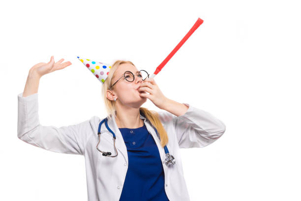 istock Woman doctor in white coat with party stuff 922802788