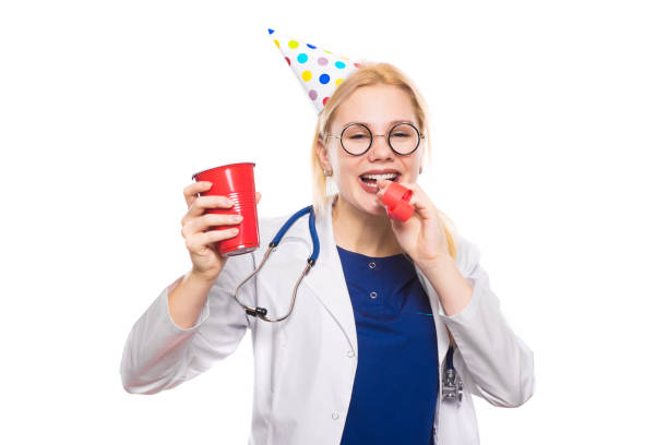 istock Woman doctor in white coat with party stuff 922802792