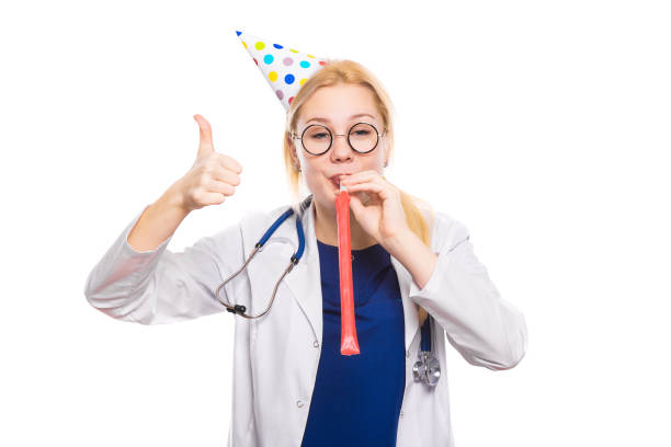 istock Woman doctor in white coat with party stuff 922802794