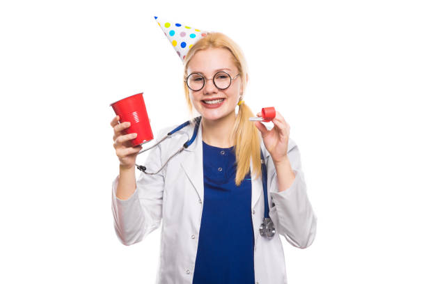 istock Woman doctor in white coat with party stuff 922802796