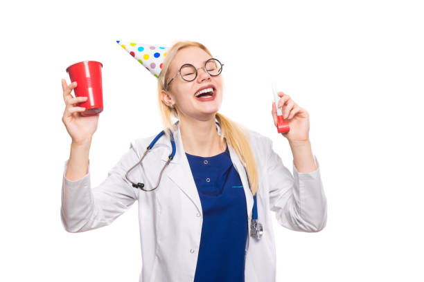 istock Woman doctor in white coat with party stuff 922802806
