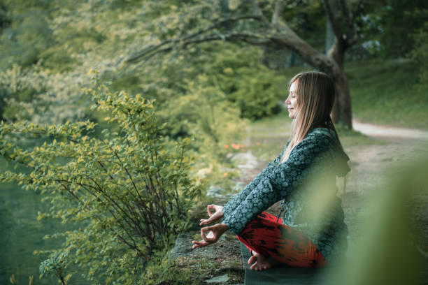istock Woman Doing Yoga By Lake 922803104