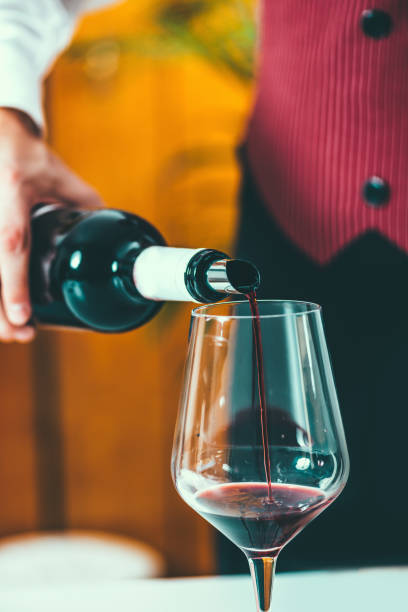 istock Midsection Of Man Pouring Wine In Wineglass On Table 922803910