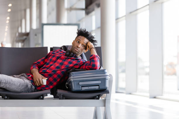 istock Young man waiting for flight in airport lounge 922806794
