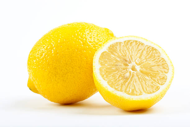 limone - isolated on yellow foto e immagini stock