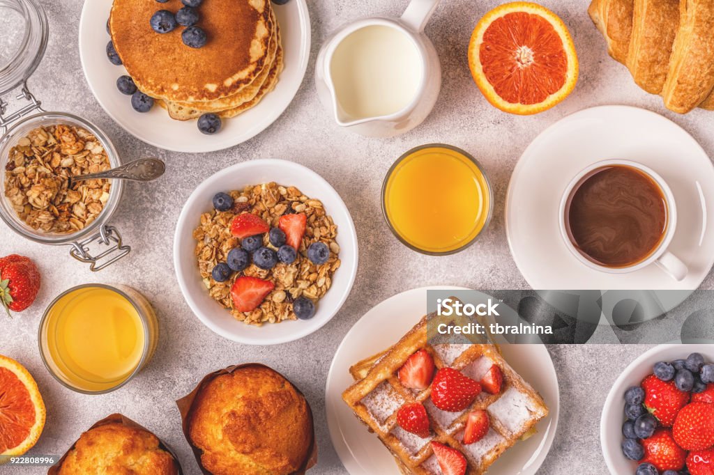 Delicious breakfast on a light table. Delicious breakfast on a light table. Top view, copy space. Apple - Fruit Stock Photo