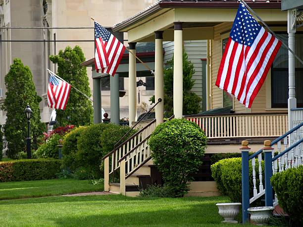 american flags volando desde la parte delantera porches - front porch fotografías e imágenes de stock