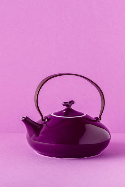 istock Purple teapot and cups on a lilac background 922809306