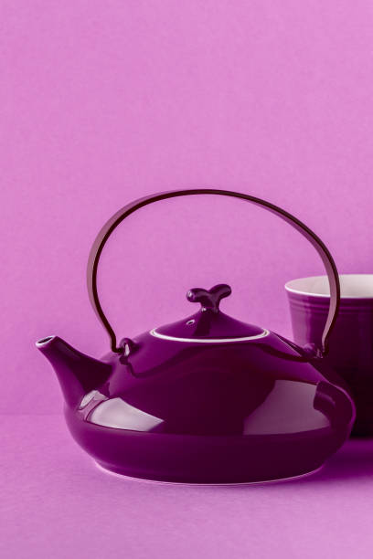 istock Purple teapot and cups on a lilac background 922809330