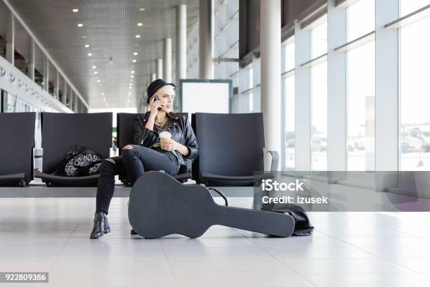 Young Funky Blond Woman Waiting For Flight In Airport Lounge Stock Photo - Download Image Now