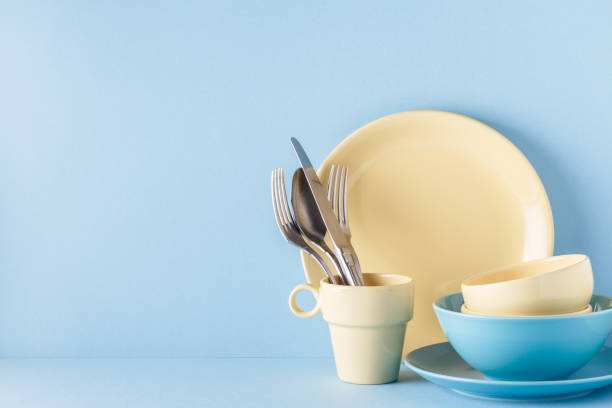 istock Crockery and cutlery on a blue pastel background 922809992