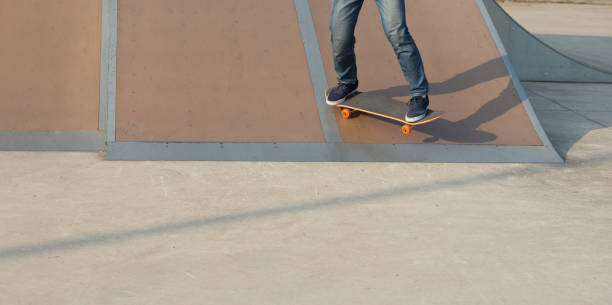 istock skateboarder legs skateboarding on skatepark ramp 922810388
