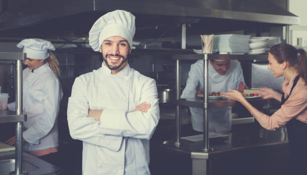 istock Portrait of satisfied smiling chef on restaurant kitchen 922814650