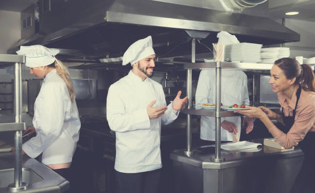 istock Staff of restaurant with young chef in kitchen 922814692