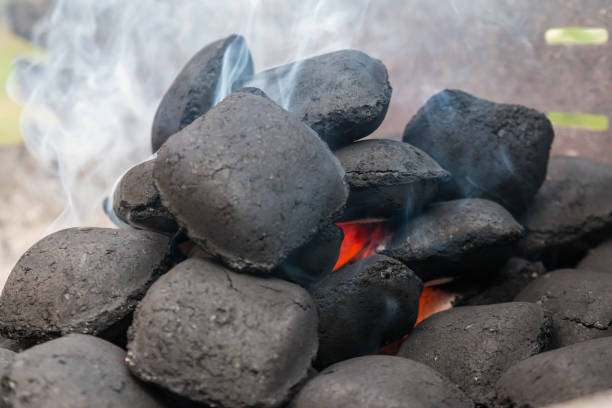 Fire up grill coal briquette stock photo
