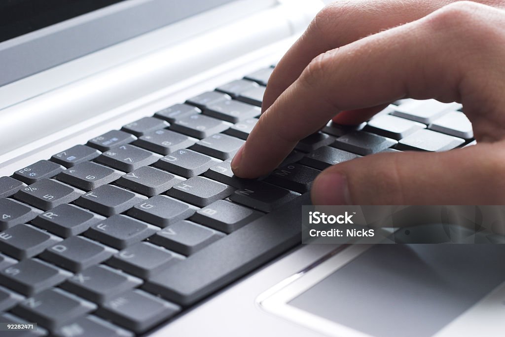 Close-up of hand on laptop keyboard Close up of a hand typing. Business Stock Photo