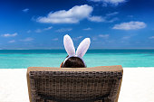 Woman with bunny ears on a tropical beach