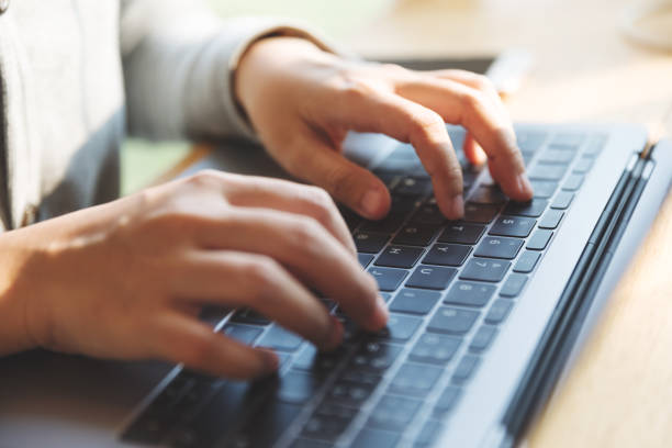 istock Women using laptop with blank screen at table in the office. 922825860