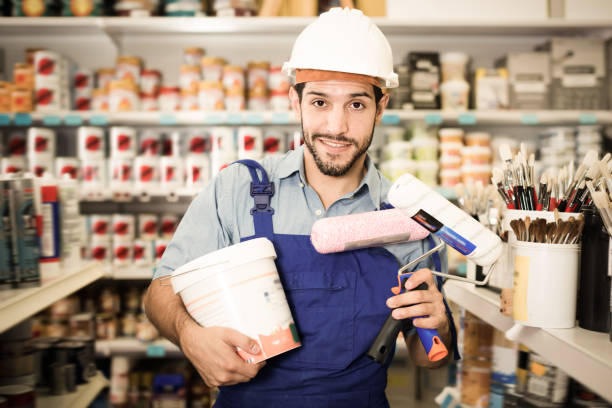 istock Portrait of adult workman holding rollers 922827572