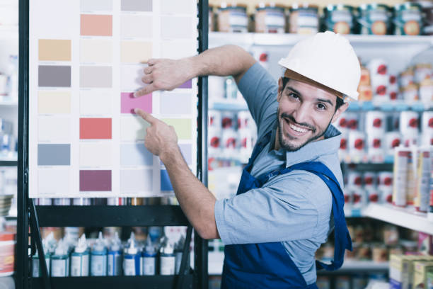 istock Smiling foreman showing samples of paint 922827650