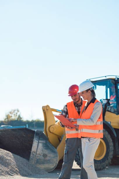 istock Man and woman worker on construction site 922829390