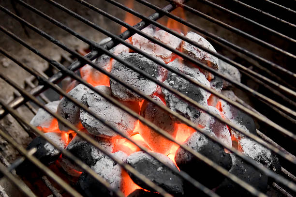 Close-up of burning charcoal under rack in a barbecue grill stock photo