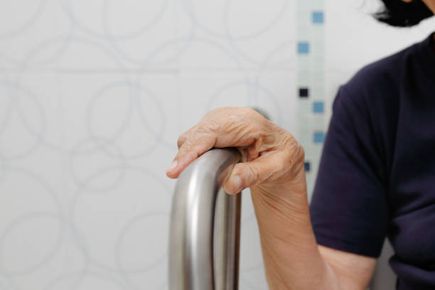 istock Elderly woman holding on handrail in bathroom. 922830234