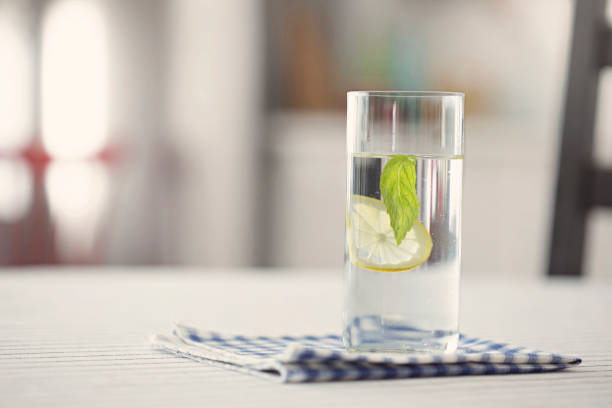 istock Glass of water with lemon and mint in kitchen 922835718