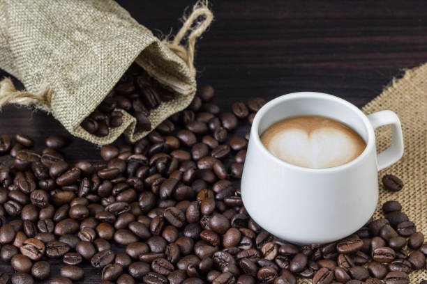 istock Close-Up Of Coffee Cup With Beans On Table 922838668
