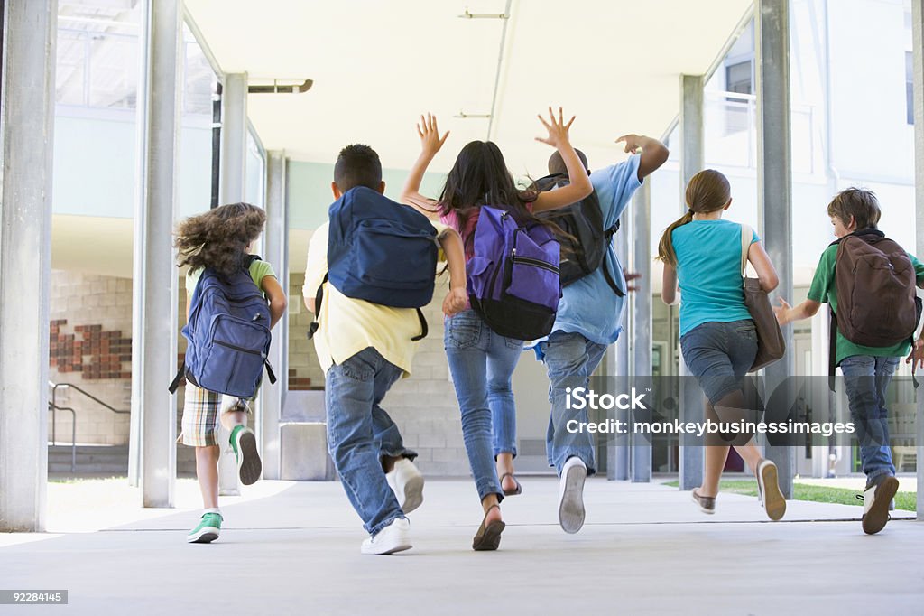 Elementary school pupils running outside  Child Stock Photo