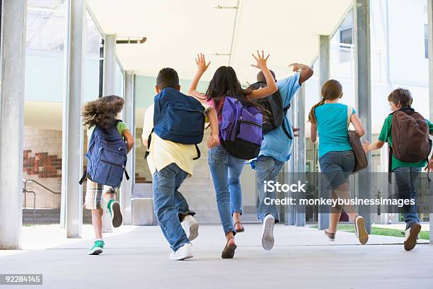 Elementary School Pupils Running Outside Stock Photo - Download Image Now - Child, Classroom, School Building