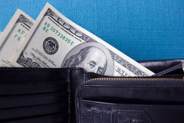 Close-up of wallet with $100 bills inside