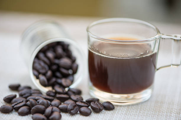 A cup of coffee and bean in glass show beverages picture