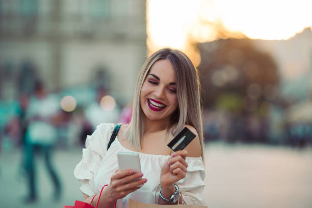 istock Beautiful Woman texting while shopping 922846114