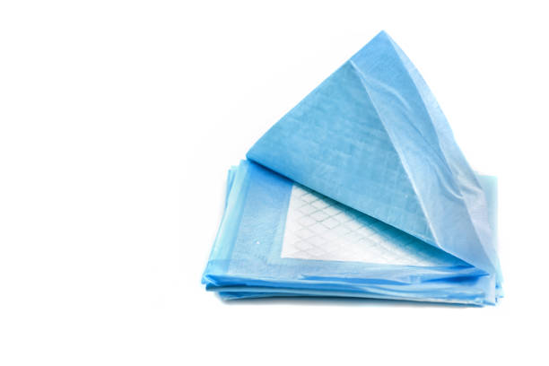 pile of absorbing pads for pets isolated on white. home training carpets for animals toilet napkins for pets isolated on white background. leak proof pads for pets accustom stock pictures, royalty-free photos & images