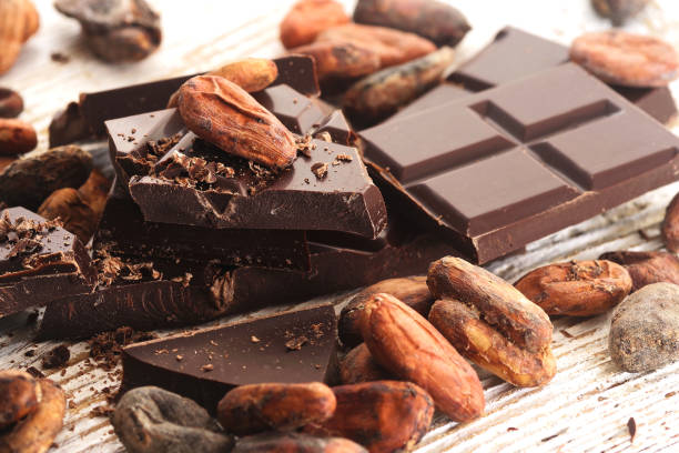 istock Broken dark chocolate, cocoa powder and coffee beans on a wooden table 922846922