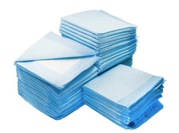 piles of toilet pads for pets isolated on white. home leak proog training pads for animals toilet napkins for pets isolated on white background. leak proof pads for pets accustom stock pictures, royalty-free photos & images