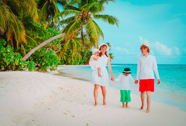 istock happy family with two kids walking on beach 922847950