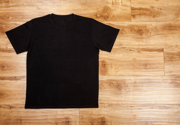 istock Black shortsleeve cotton tshirt on a wooden backgronud 922855108