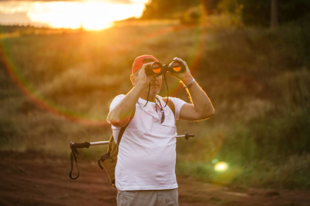 istock Senior man is looking at birds 922860436