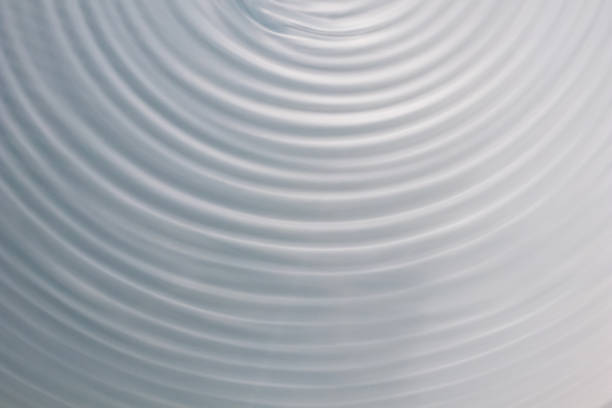istock circular wave motion in a fluid system. blue gray background for a liquid pushed into a circular motion. 922861186