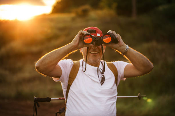 istock Senior man is looking at birds 922863414