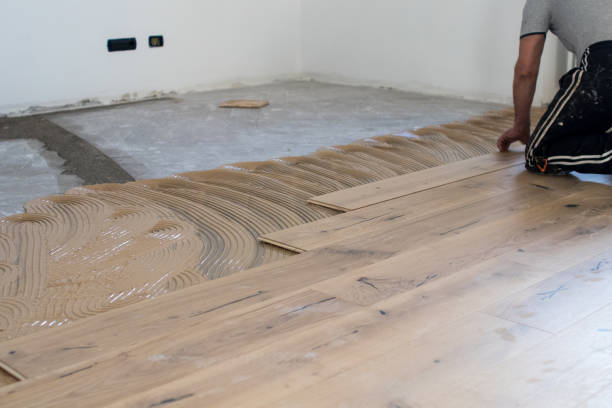 istock Oak colored parquet during installation on an old stoneware floor near an open window. 922864670