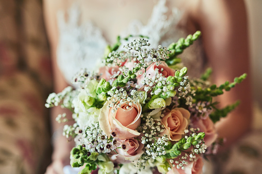 Shot of an unrecognizable woman holding a bouquet of flowers at a wedding