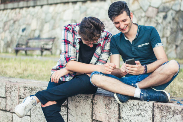istock Two friends watch funny things on a mobile phone. 922872874
