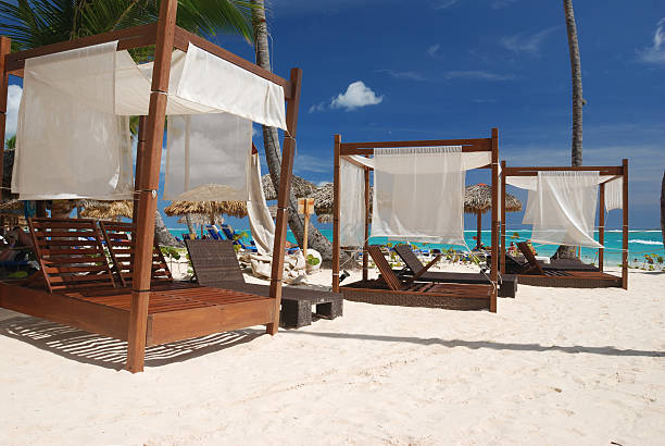 istock Luxury wooden chaise lounges on a white sandy beach 92287585