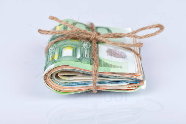 istock A bundle of euro bills tied with a rope and placed on white 922875870