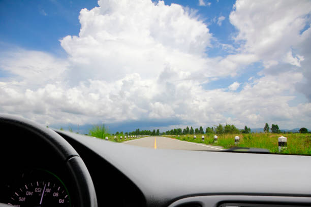 istock Road trip through the mountains. View from the car.Empty country road with cloudy sky 922876310