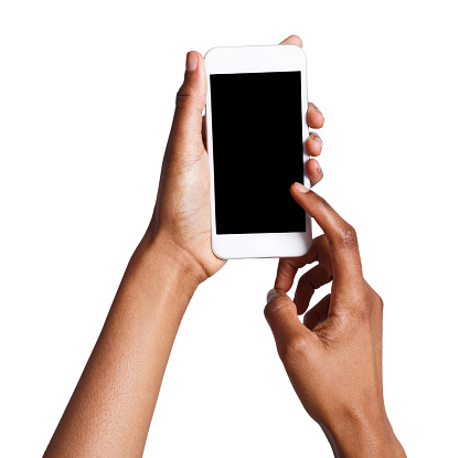 Black female hand touching mobile phone display and pointing with index finger on blank screen, white isolated background, copy space, cutout
