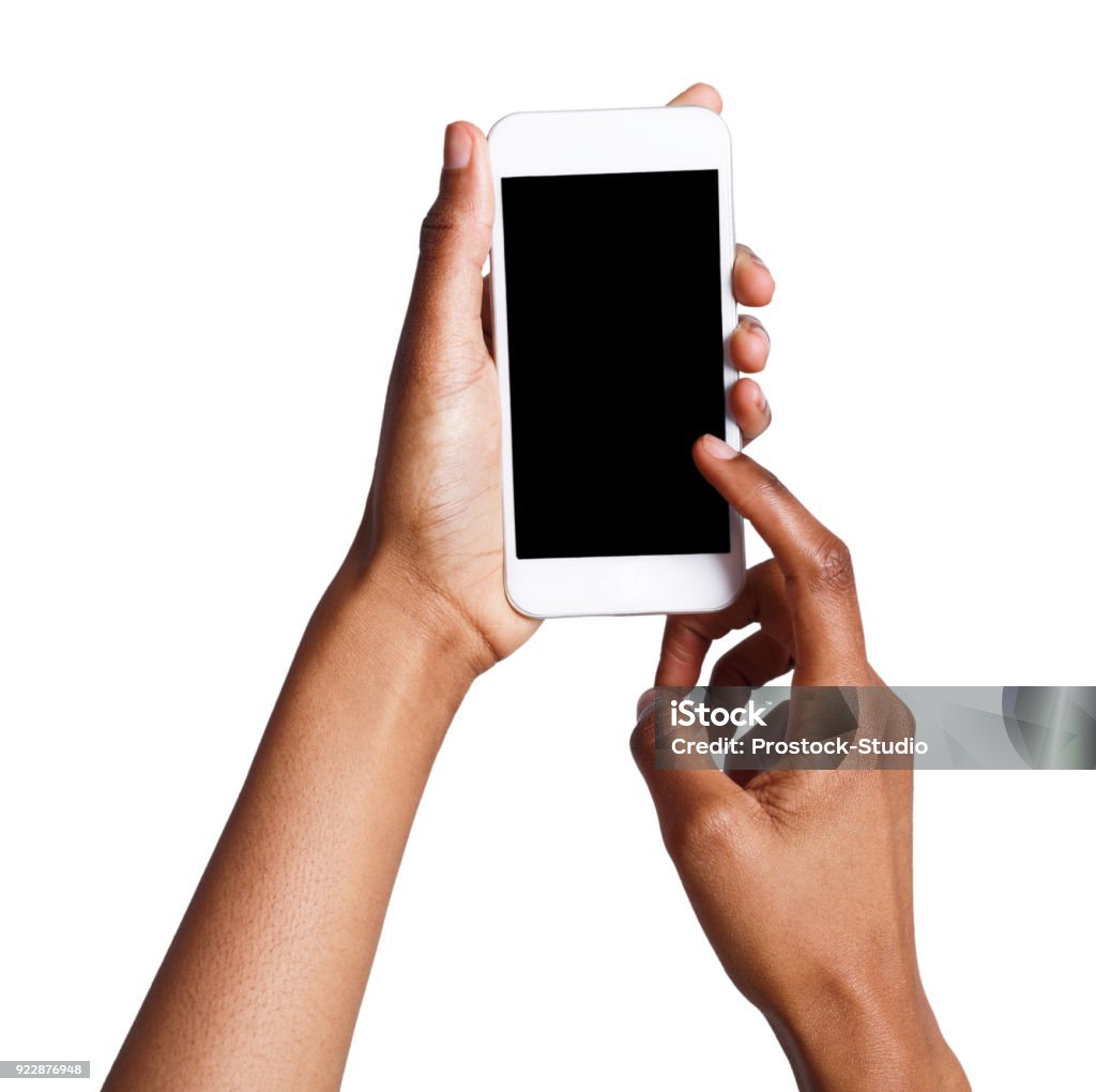 Female hands pointing on blank mobile phone screen Black female hand touching mobile phone display and pointing with index finger on blank screen, white isolated background, copy space, cutout Telephone Stock Photo